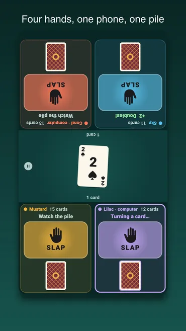 Four players round one phone: a seat in each corner with its own deck and slap pad, and the pile in the middle